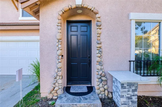 a front view of a house with a shower and plants