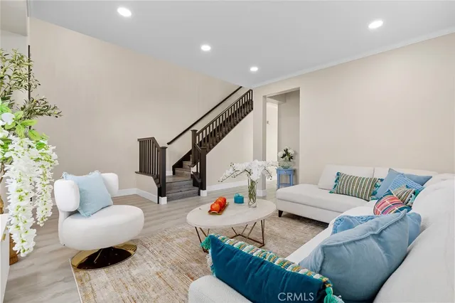 a living room with furniture and a potted plant