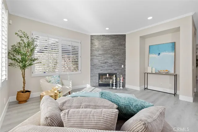 a kitchen with stainless steel appliances a stove a sink a refrigerator cabinets and a dining table