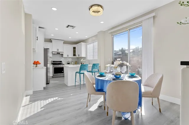 a kitchen with granite countertop a refrigerator stove top oven and cabinets