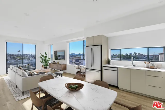 a kitchen with a table chairs stove and refrigerator