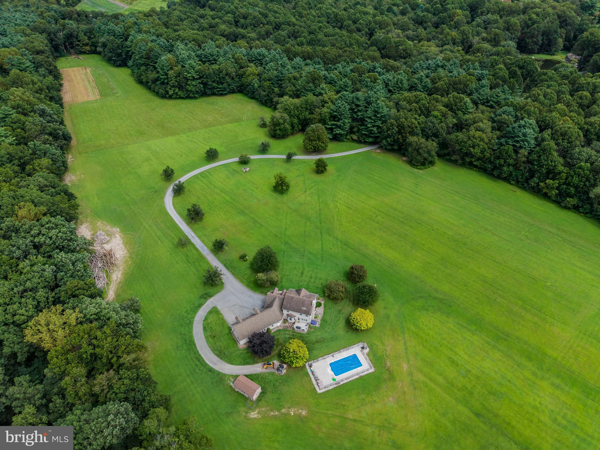 swimming pool view with a garden