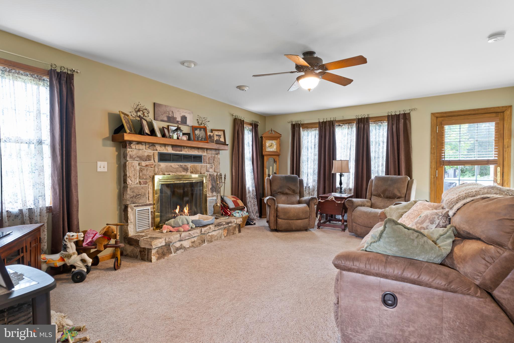 392 Peach Glen Road Gardners, PA 17324 - Photo 50 of 72 a living room with furniture ceiling fan and a fireplace