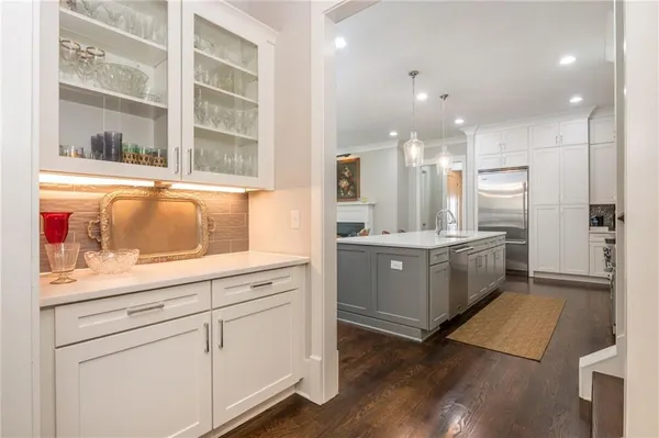 a large kitchen with stainless steel appliances kitchen island granite countertop a large center island and a sink