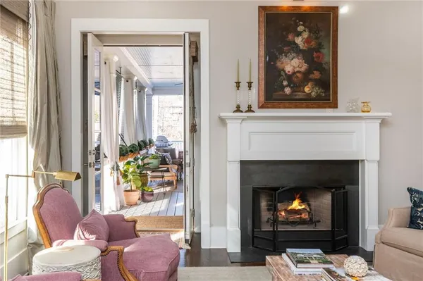 a hallway with wooden floor and a rug