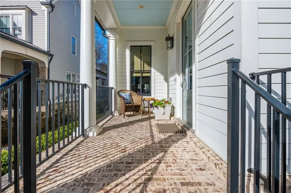 a view of a balcony with chair and wooden floor