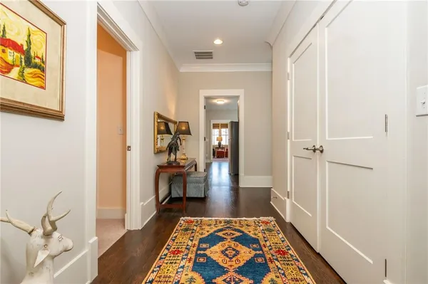 a view of a hallway with a livingroom and furniture