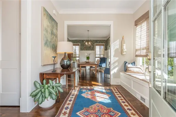 a living room with furniture and a potted plant