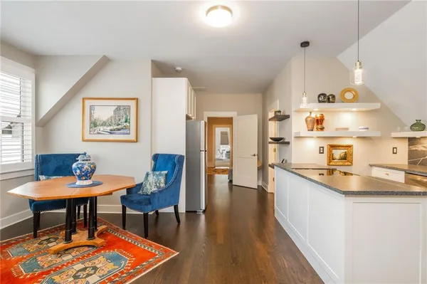 a living room with furniture a flat screen tv and kitchen view