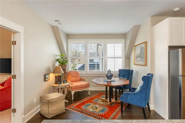a bathroom with a granite countertop bathtub shower sink mirror and toilet