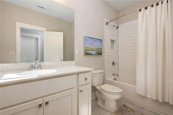 a view of parking with cars parked on the roadside