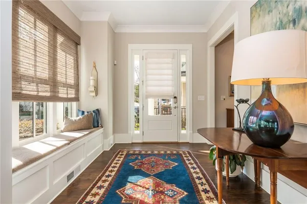 a bedroom with furniture and a large window