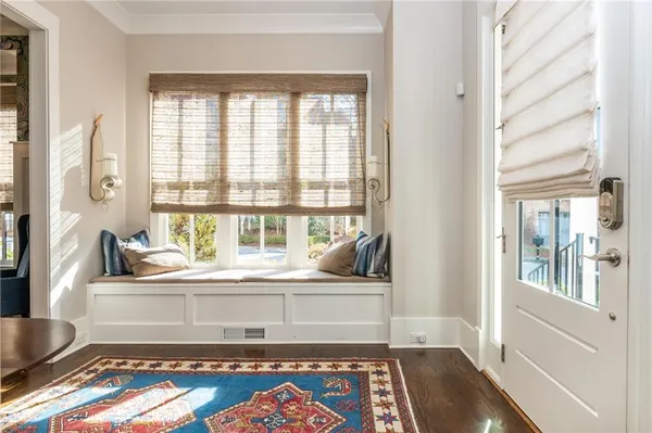 a living room with a bed furniture and a large window