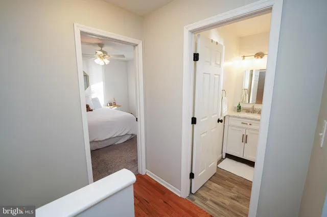 a spacious bedroom with a bed and a flat screen tv