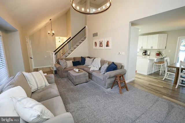 a kitchen with a refrigerator a sink and wooden floor
