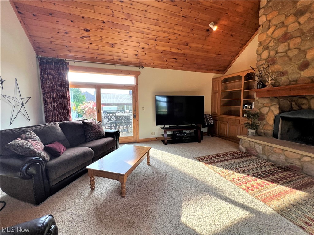 607 Bryan Road Milan, OH 44846 - Photo 11 of 34 Carpeted living room with wood ceiling, vaulted ceiling, and a fireplace