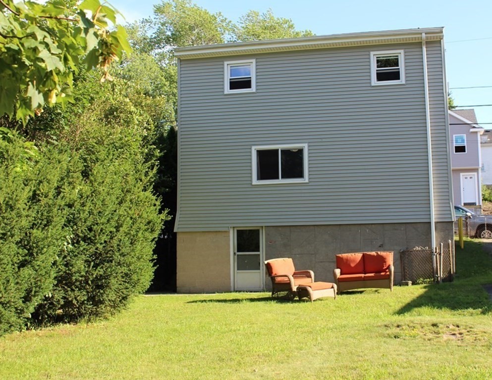 382 Tecumseh Street Fall River, MA 02721 - Photo 4 of 36 a view of a house with a yard and sitting area