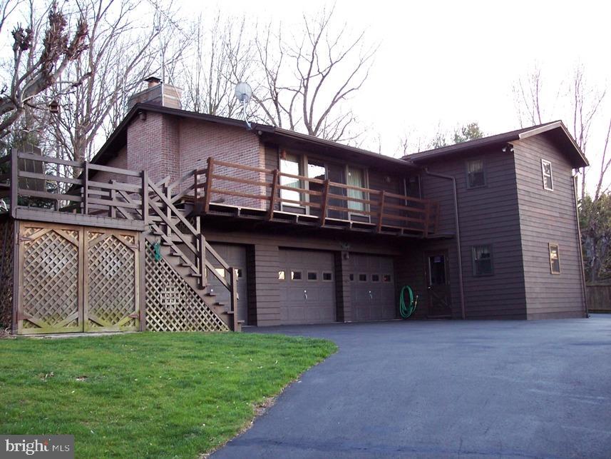 560 Blue Lake Road Denver, PA 17517 - Photo 3 of 27 a front view of a house with a garden