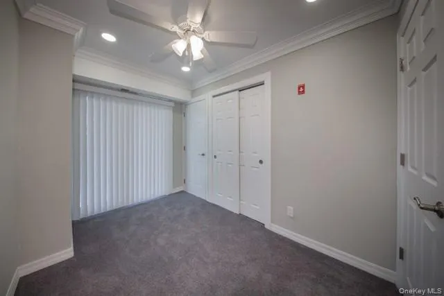 en empty room with windows and fan