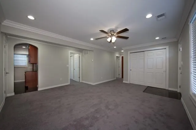 a view of an empty room with a ceiling fan