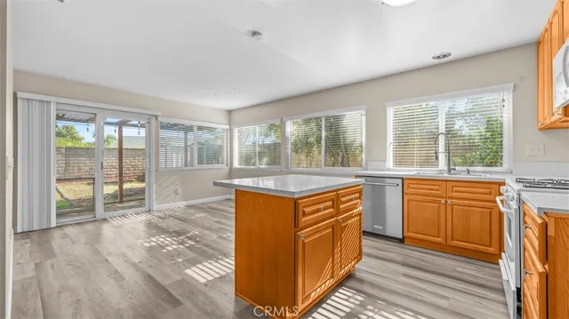 a kitchen with stainless steel appliances granite countertop a stove a sink and a refrigerator