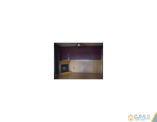 79 F Farm Road Hillsborough, NJ 08844 - Photo 3 of 5 a living room with a chair