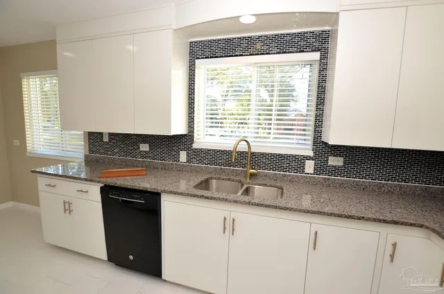 a kitchen with stainless steel appliances granite countertop a refrigerator and a stove