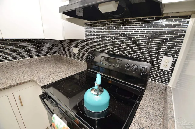 a view of a dining room with a table and chairs