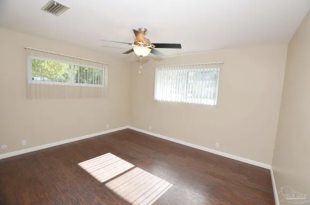 a hallway with a flower pot and a table