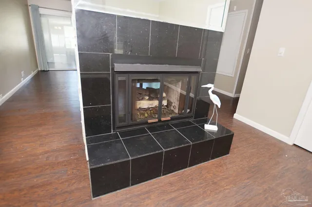 a kitchen with stainless steel appliances granite countertop a refrigerator a stove a sink a dining table and chairs