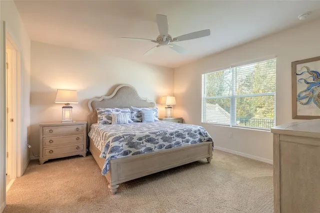 a bedroom with a large bed and a flat screen tv