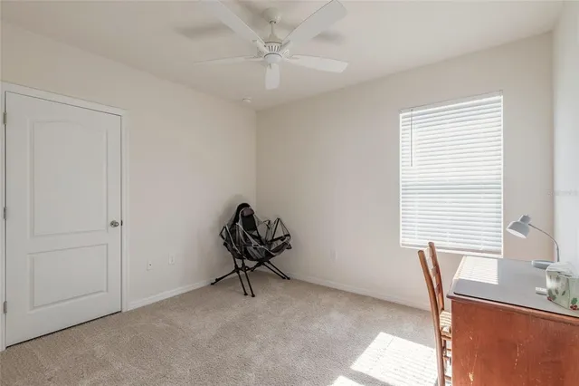a view of a livingroom with furniture and a ceiling fan