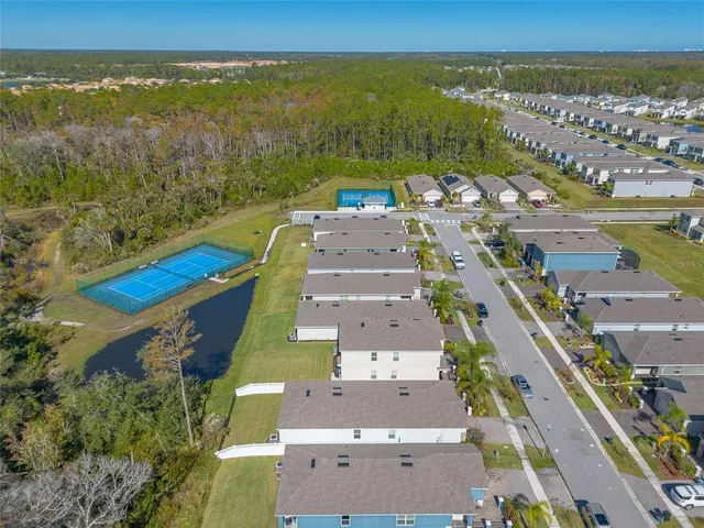 an aerial view of residential houses with outdoor space