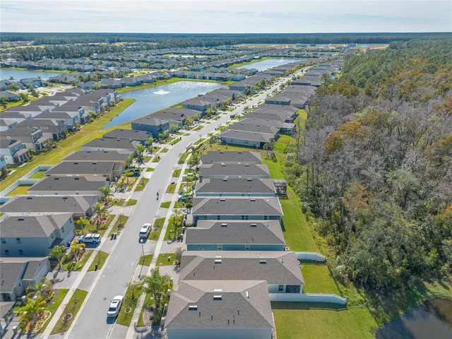 an aerial view of a house with a yard
