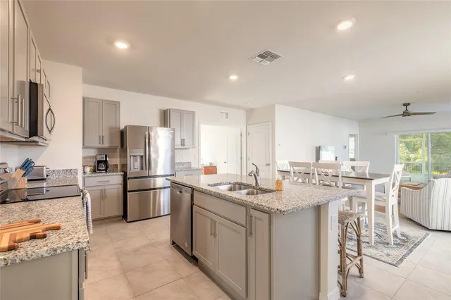 a kitchen with refrigerator and cabinets