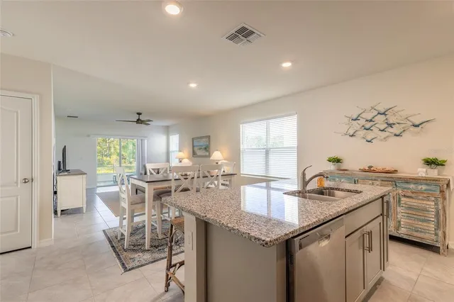 a kitchen with granite countertop cabinets stainless steel appliances a sink and a island
