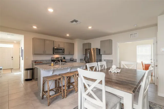 a view of a dining room with furniture and window