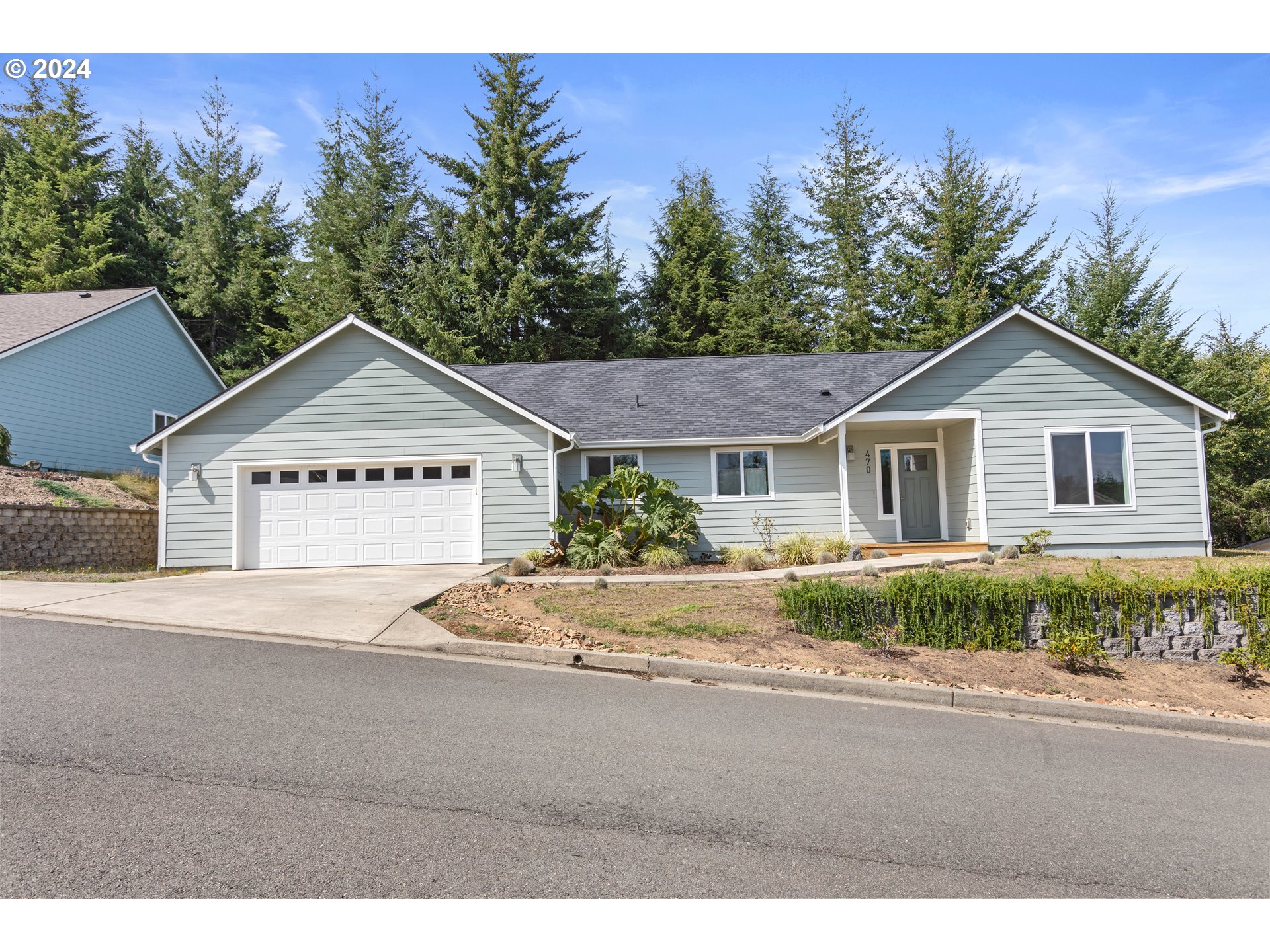 470 Providence Drive Reedsport, OR 97467 - Photo 1 of 41 a view of a house with a yard and potted plants