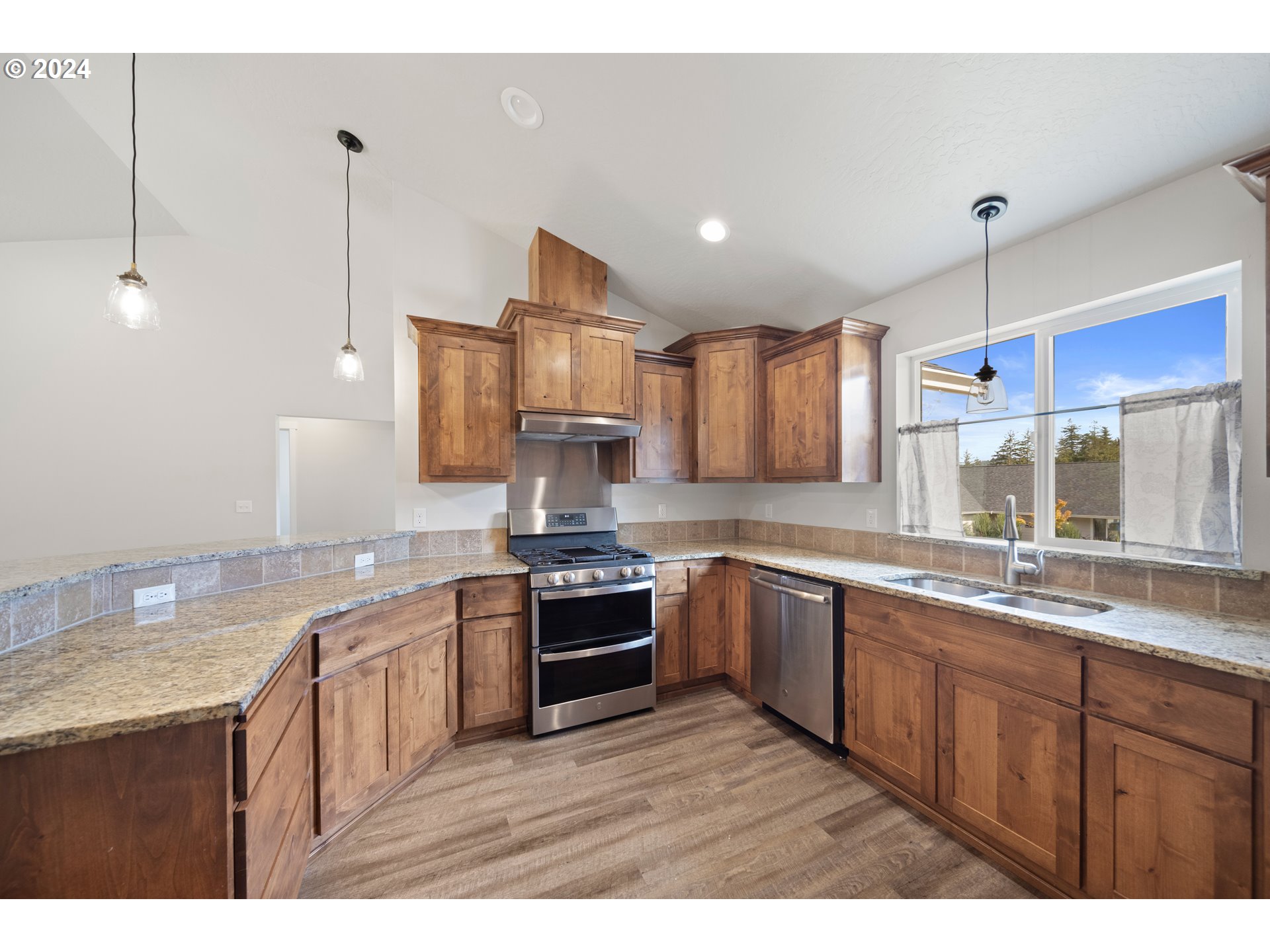 470 Providence Drive Reedsport, OR 97467 - Photo 11 of 41 a kitchen with stainless steel appliances granite countertop wooden cabinets sink and stove