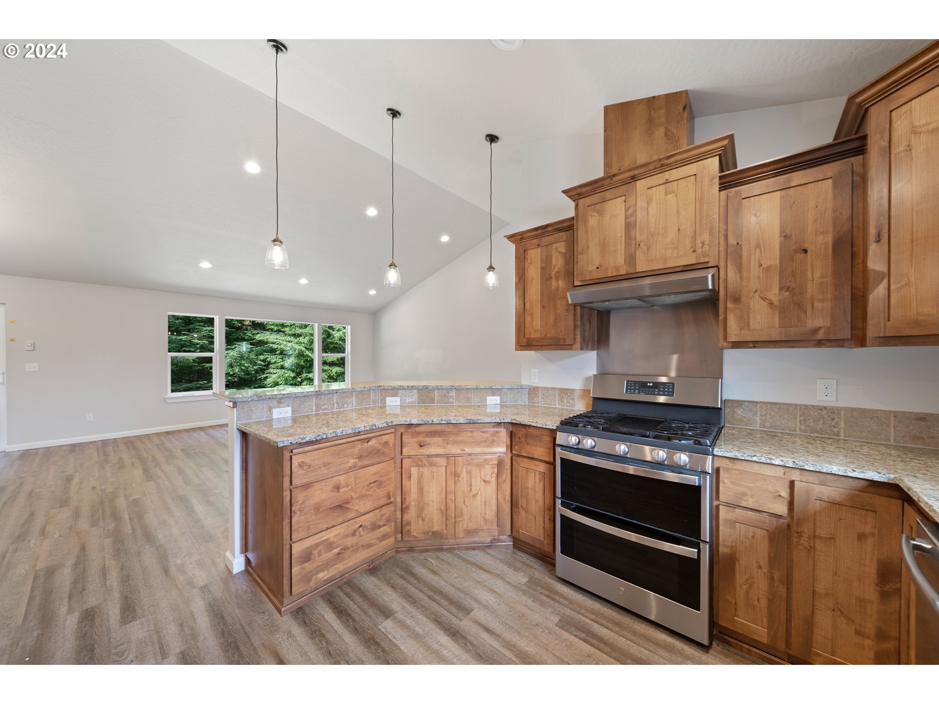 470 Providence Drive Reedsport, OR 97467 - Photo 12 of 41 a kitchen with stainless steel appliances granite countertop a stove sink and cabinets
