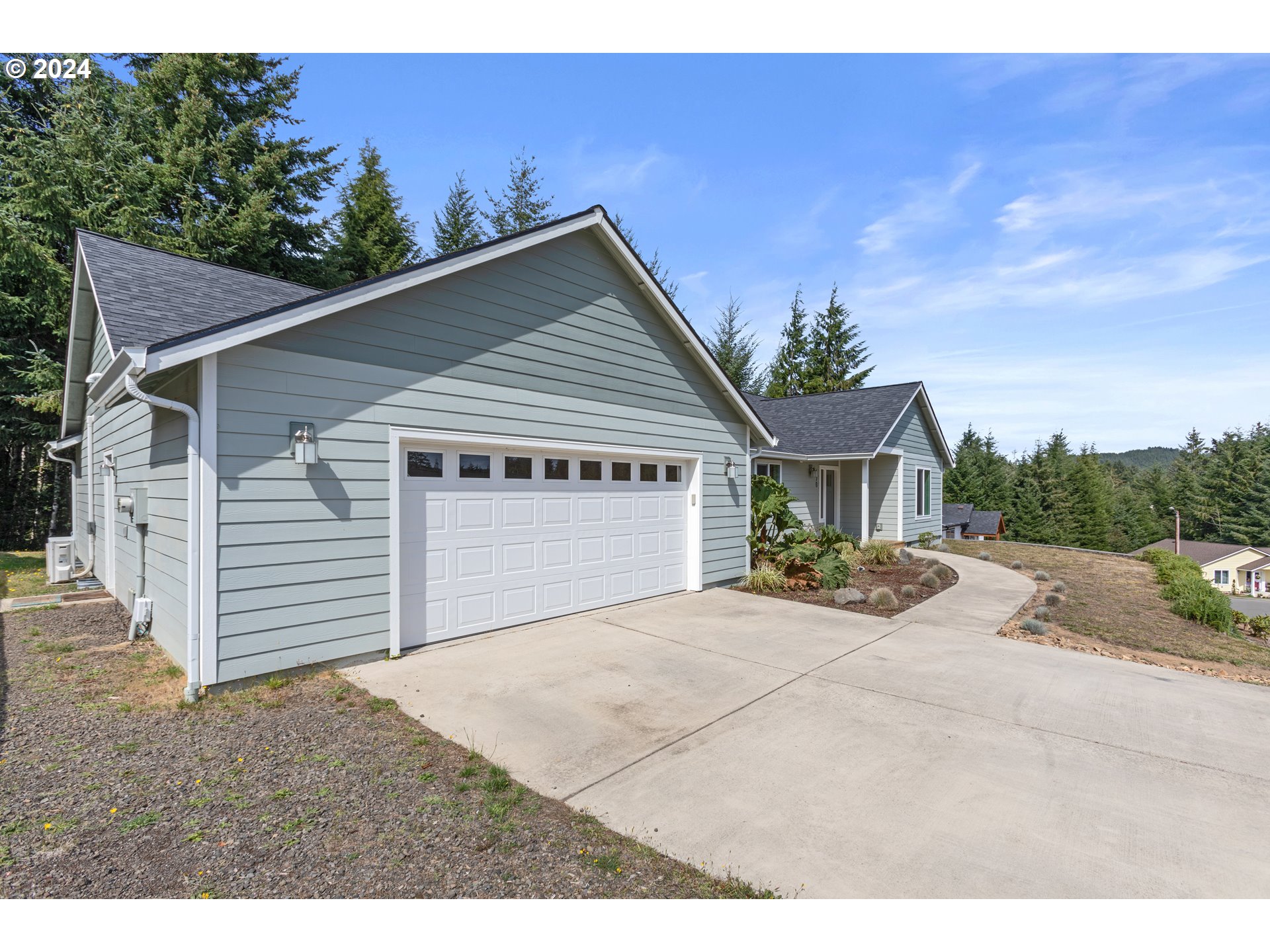 470 Providence Drive Reedsport, OR 97467 - Photo 2 of 41 a view of a house with a yard and garage