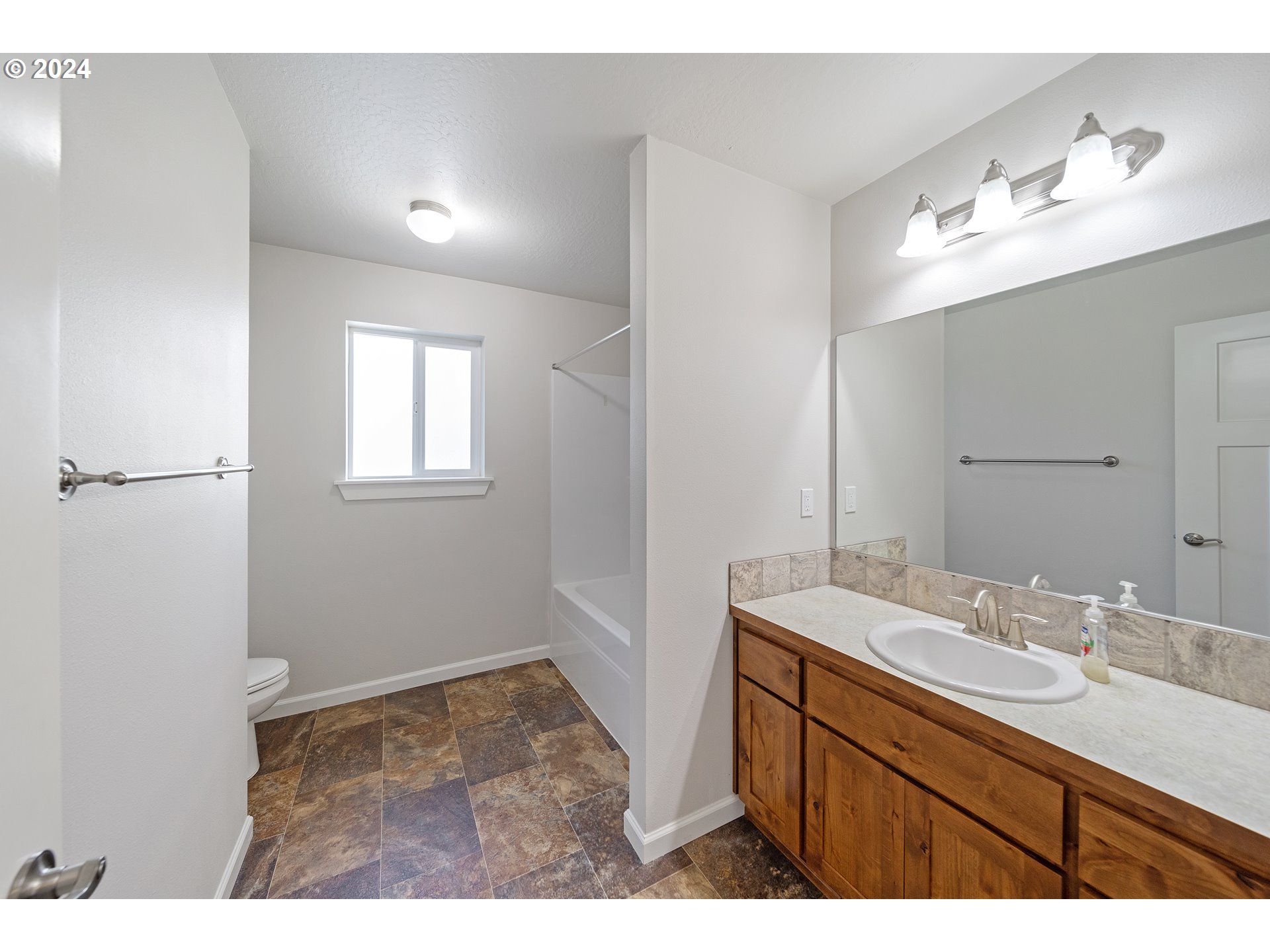 470 Providence Drive Reedsport, OR 97467 - Photo 25 of 41 a bathroom with a sink vanity and a mirror