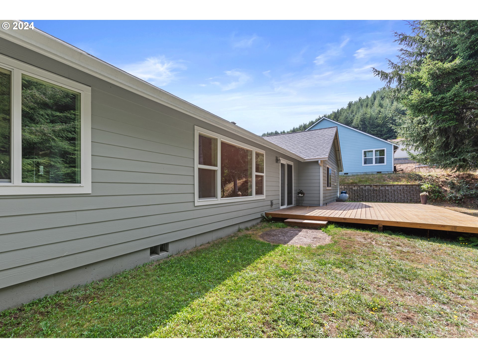 470 Providence Drive Reedsport, OR 97467 - Photo 33 of 41 a view of a house with swimming pool and a yard