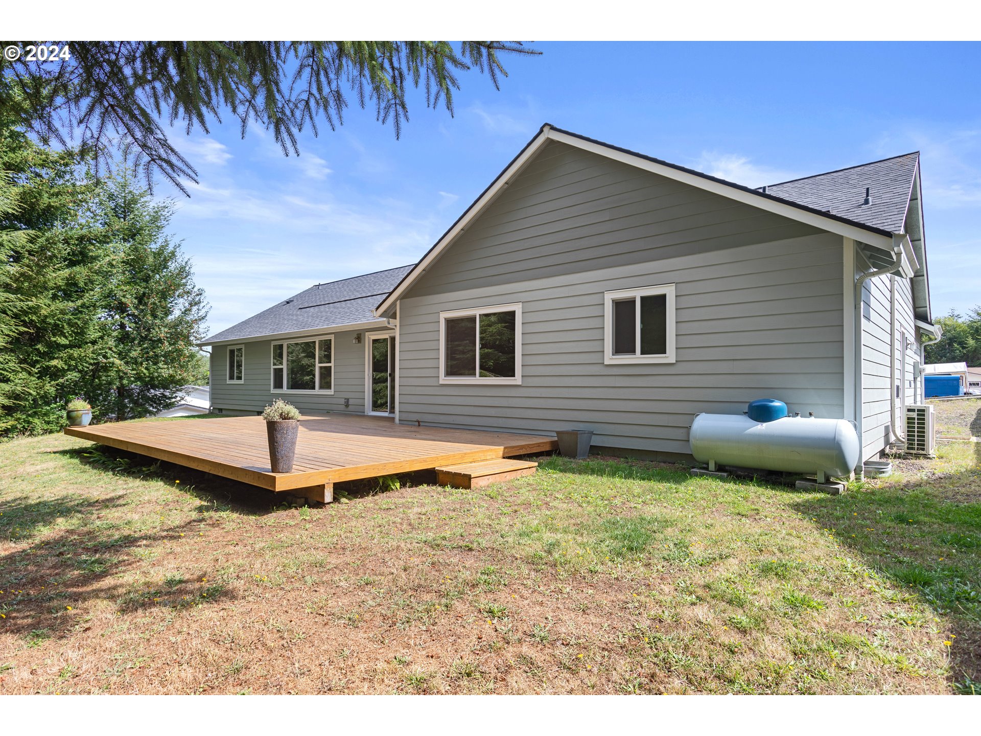 470 Providence Drive Reedsport, OR 97467 - Photo 34 of 41 a backyard of a house with yard and outdoor seating