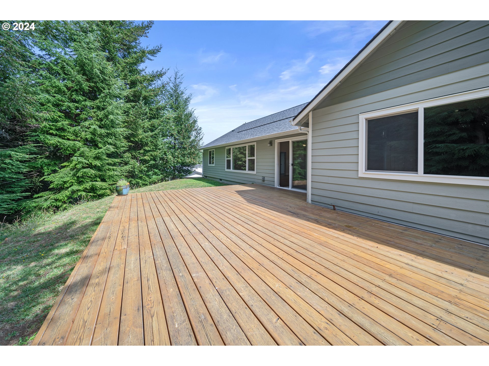 470 Providence Drive Reedsport, OR 97467 - Photo 35 of 41 a view of backyard with a deck and wooden floor