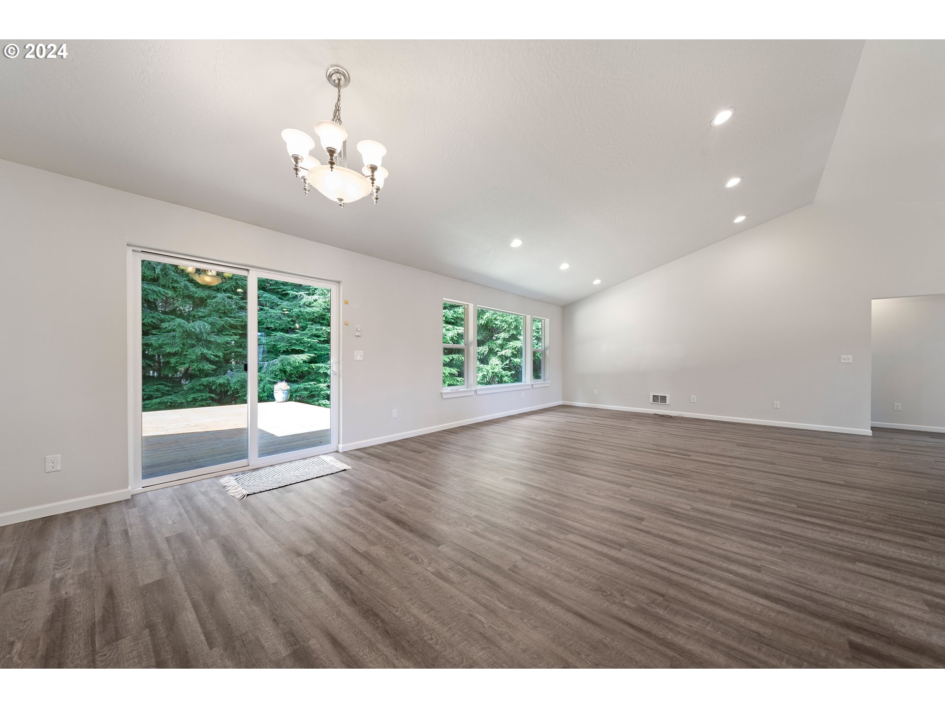 470 Providence Drive Reedsport, OR 97467 - Photo 9 of 41 a view of an empty room with wooden floor and a window