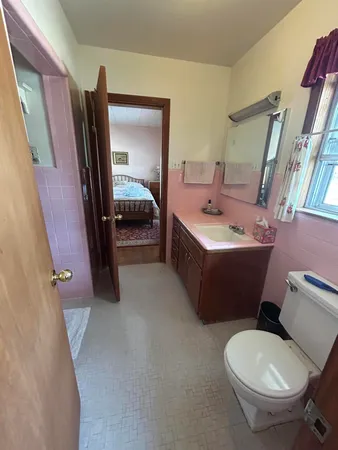 a bathroom with a sink toilet and mirror