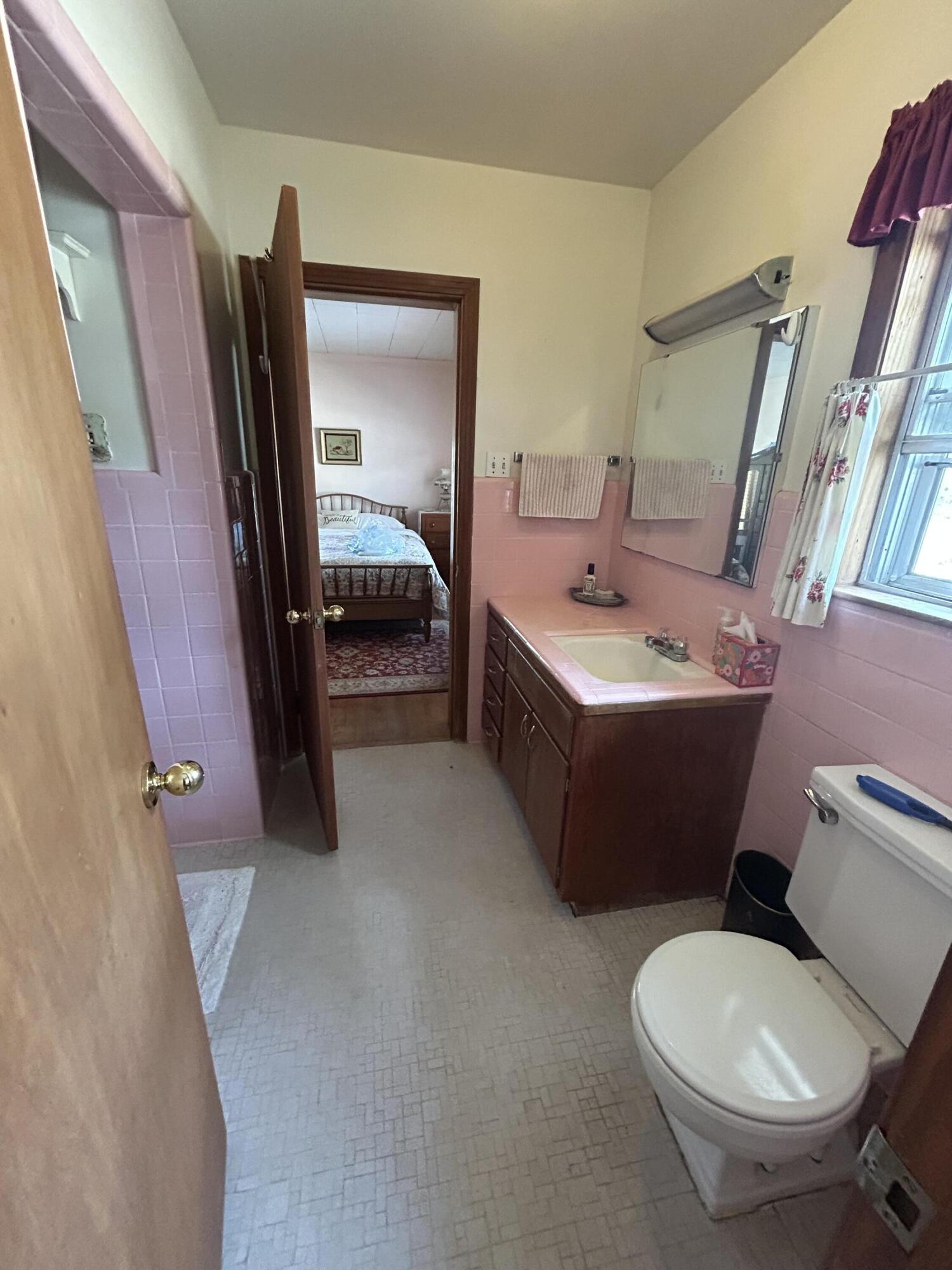 7151 Co Highway 280 DeFuniak Springs, FL 32435 - Photo 11 of 15 a bathroom with a sink toilet and mirror