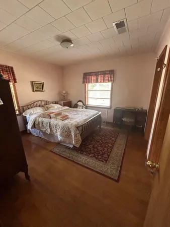 a bed sitting in a bedroom next to a window