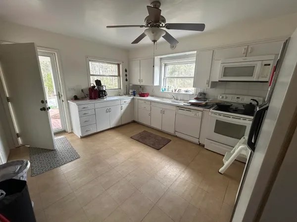 a kitchen with a sink stove and refrigerator